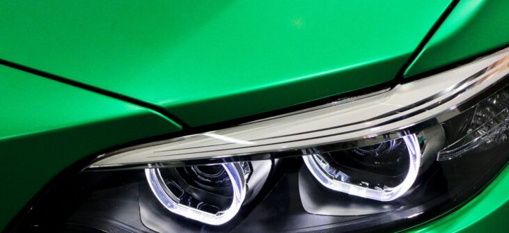 a close up of the headlights of a green car